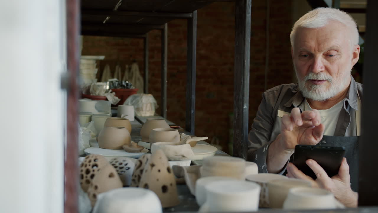 Senior Craftsman Working on Pottery in His Studio