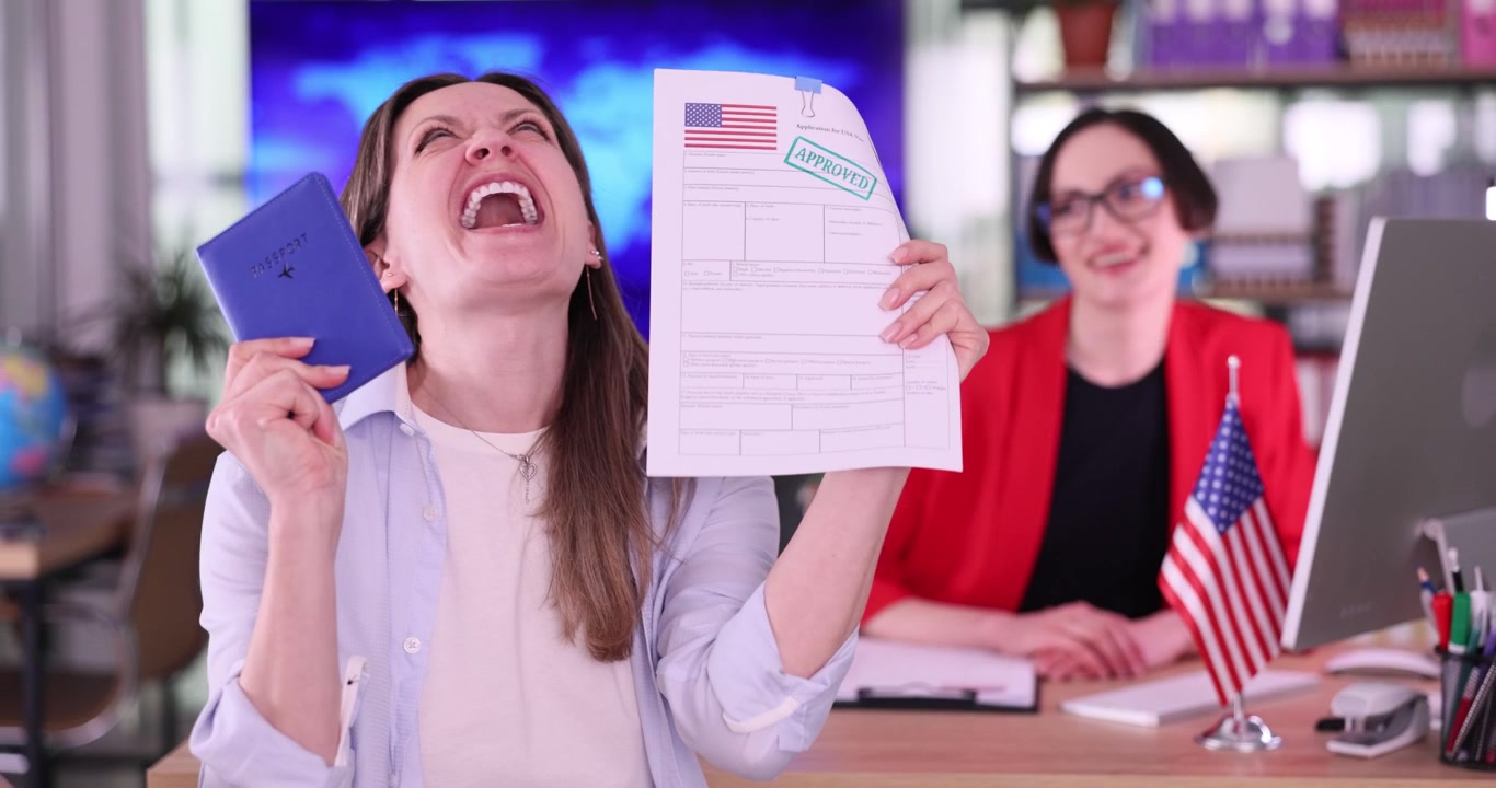 Joyful woman smiles holding approved american visa documents