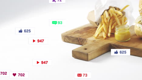 social media notifications animation over wooden board with fries and cheese