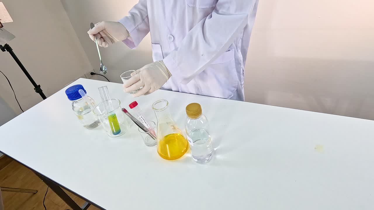 Scientist conducts a vibrant bromothymol blue experiment, showcasing chemical reactions on a laboratory table with bright lighting