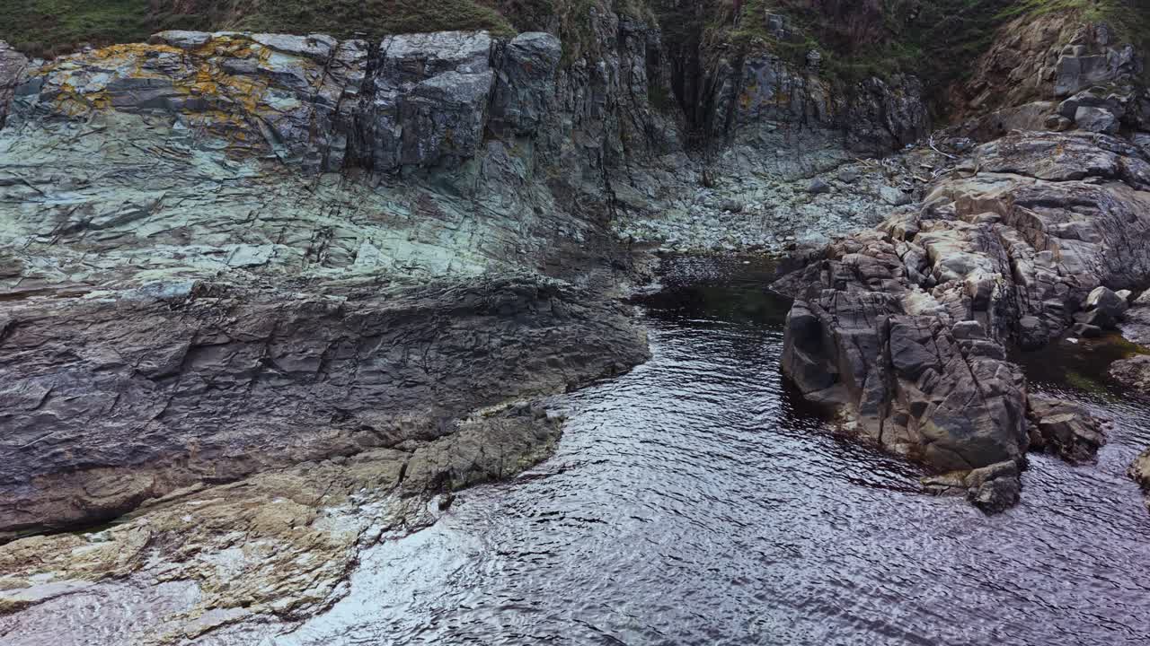 Scenic aerial view of rocky shoreline and calm water