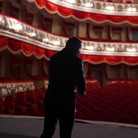 presenter with microphone speaks with the empty auditorium. concept of quarantine,cancellation of mass events to prevent spread of coronavirus infection