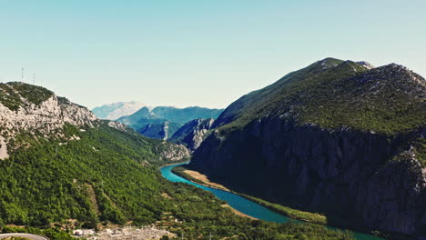 aerial camera flying forward on a wide shot of a epic mountain scenery on beautiful day