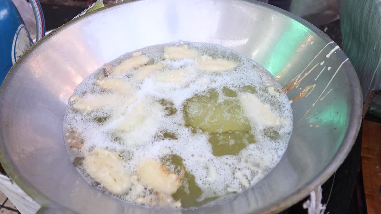 rebanadas de plátanos fritos en aceite caliente