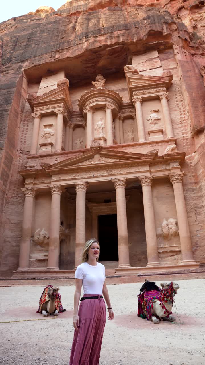 Tourists Couple Kissing In Front Of Al-Khazneh Ancient Rock-Cut Facade In Petra Jordan, Vertical View
