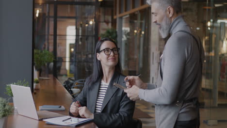 businesswoman and waiter in cafe