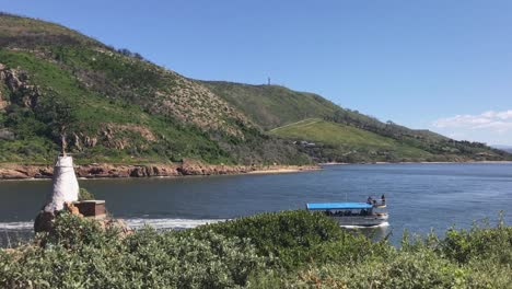 loaded tourboat passes e heads beacon, returning to port in knysna