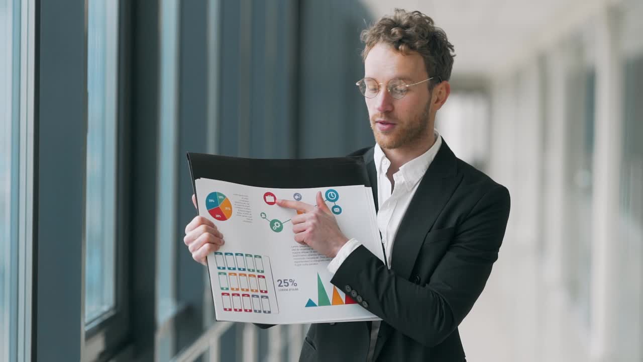 Young handsome businessman man gives a presentation on infographics