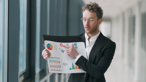 young handsome businessman man gives a presentation on infographics