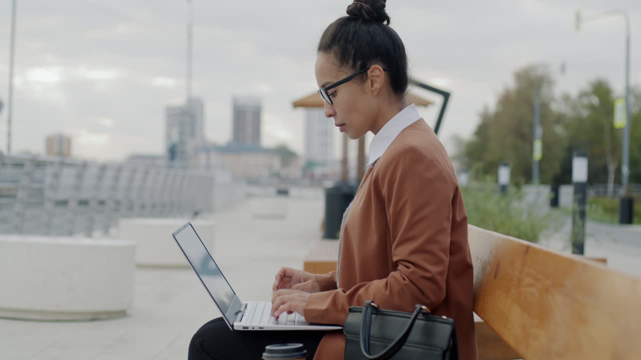 Businesswoman Working Outdoors on Laptop