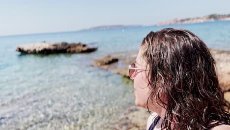 young woman capturing raw beach moments at vouliagmeni