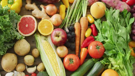 video of fresh fruit and vegetables over wooden background