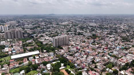 Top-shot-of-traditional-Indian-houses-and-tall-apartments-at-Chennai-with-cityscape-at-background-in-India