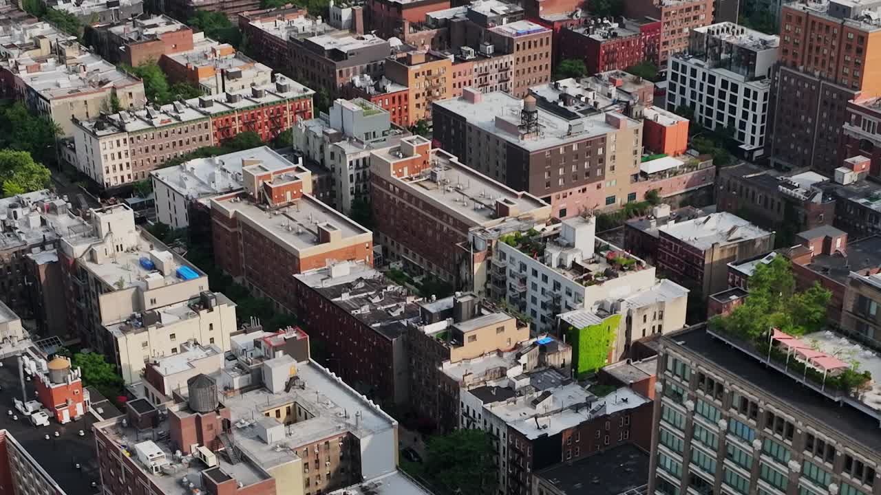 Drone view of New York City showcasing urban rooftops and skyline