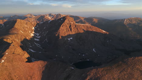 First light golden sunrise early morning aerial drone view Mount of the Holy Cross 14er peak Wilderness Halo Ridge Trail Notch mountain Bowl of Tears lake Sawatch Range Rocky Mountains Colorado circle