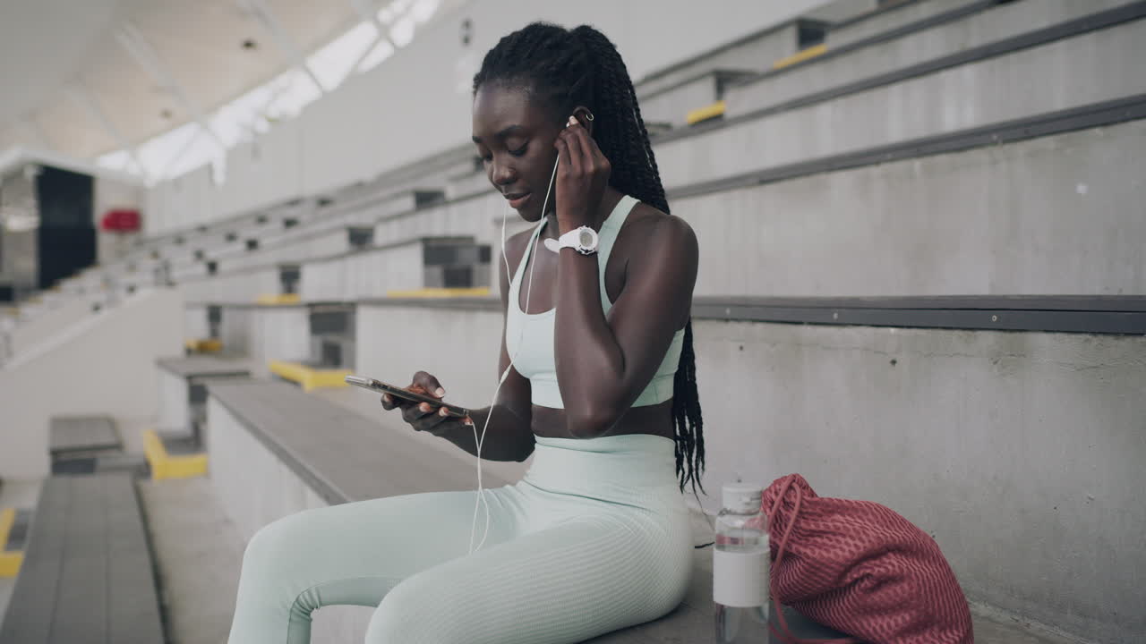 Woman relaxing at stadium in sportswear