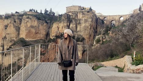 dolly shot of a beautiful woman walking along an observation deck at ronda, spain