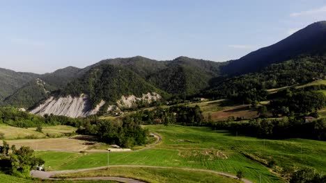 a drone flies above emilia romagna hills approaching a villa