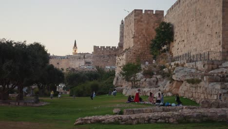 jewish families playing outside the old city of jerusalem walls in the holy city israel