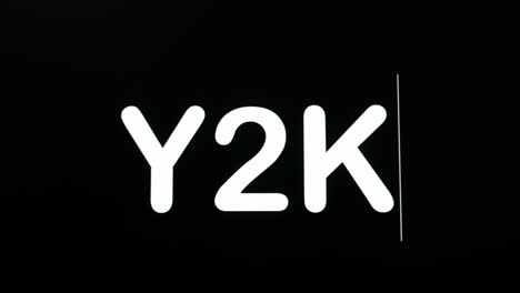 close up of y2k being typed into computer monitor screen with blinking cursor on black background copy space