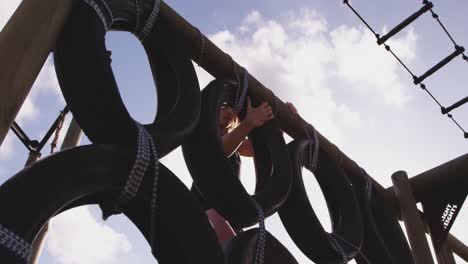 young woman training at an outdoor gym bootcamp