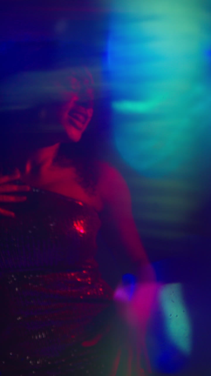 Vertical Video Of Young Woman In Nightclub Bar Or Disco Dancing With Sparkling Lights In Background 1