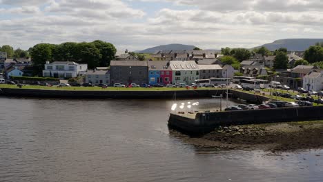 Aerial-orbit-of-Kinvara-Pier,-colorful-houses,-and-quays