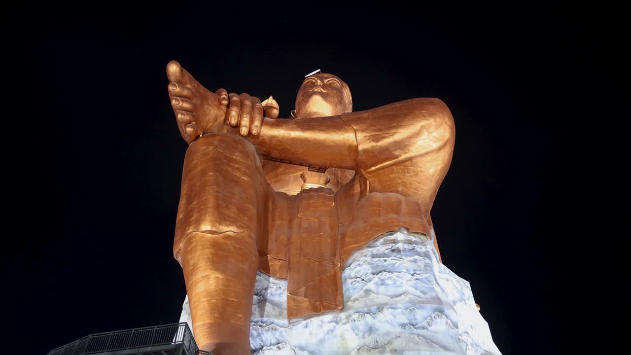 Night View of a Giant Seated Bronze Statue
