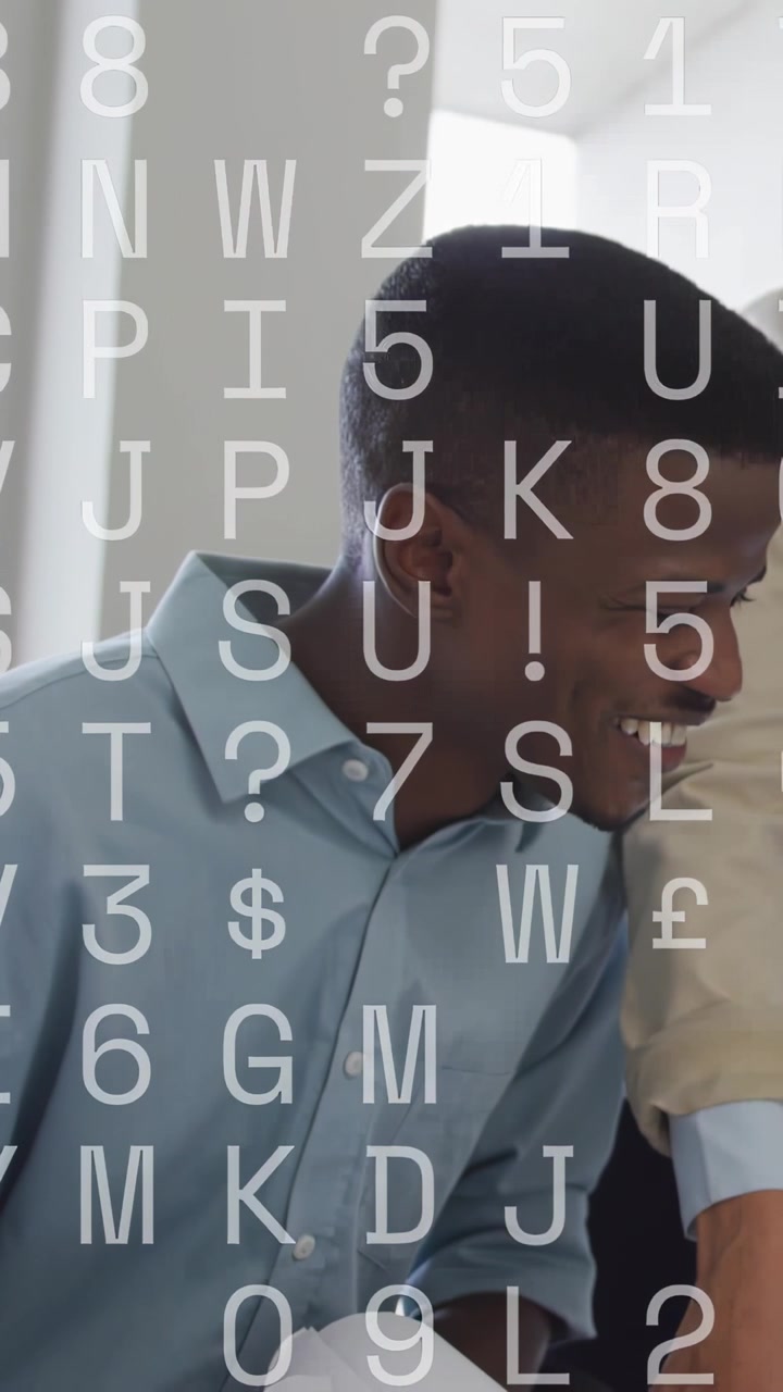 Vertical video: Man leaning laughing as peer pointing reviewing papers in office, overlaying faces
