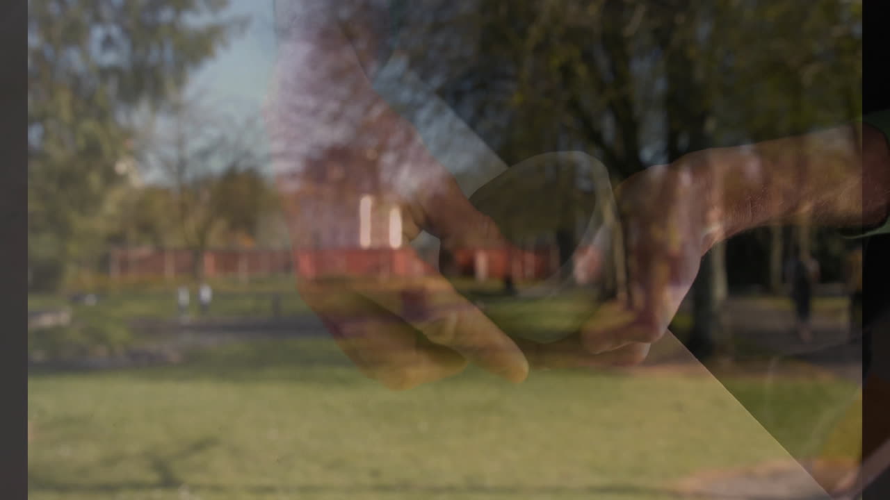 Holding bowl, person standing in park with trees and grass in background