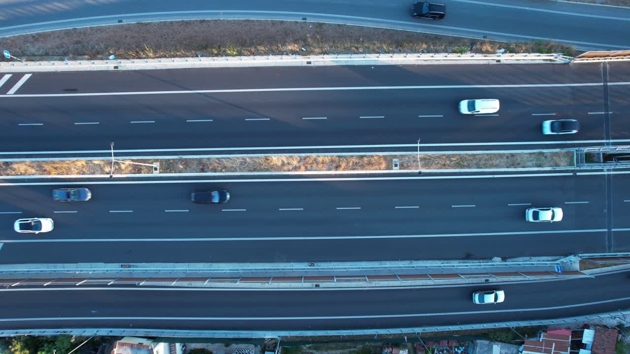 Top-down aerial view of Tirana ring road highway at twilight with cars traffic, and transport infrastructure
