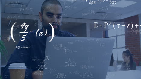 animation of equations at elements over happy biracial male student using laptop in classroom