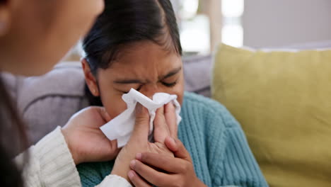 sick, young child and tissue with blowing nose