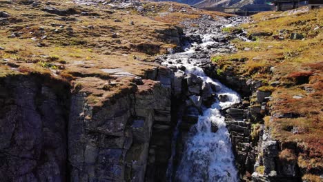 waterfall flowing down the rugged cliff in high tauern national park in austria