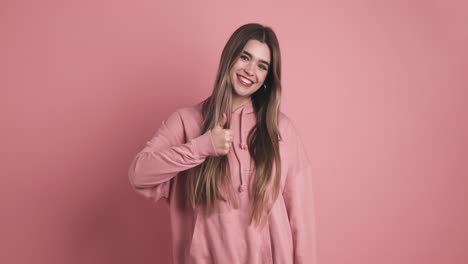 happy young woman showing thumb up gesture