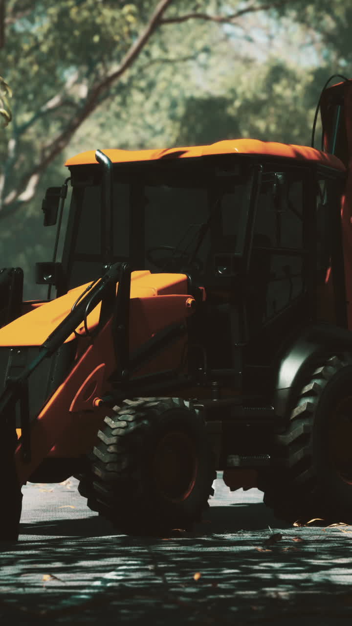 retroexcavadora naranja en un parque