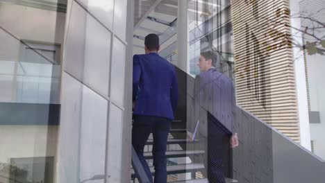 animation of office building over businessmen talking in modern office