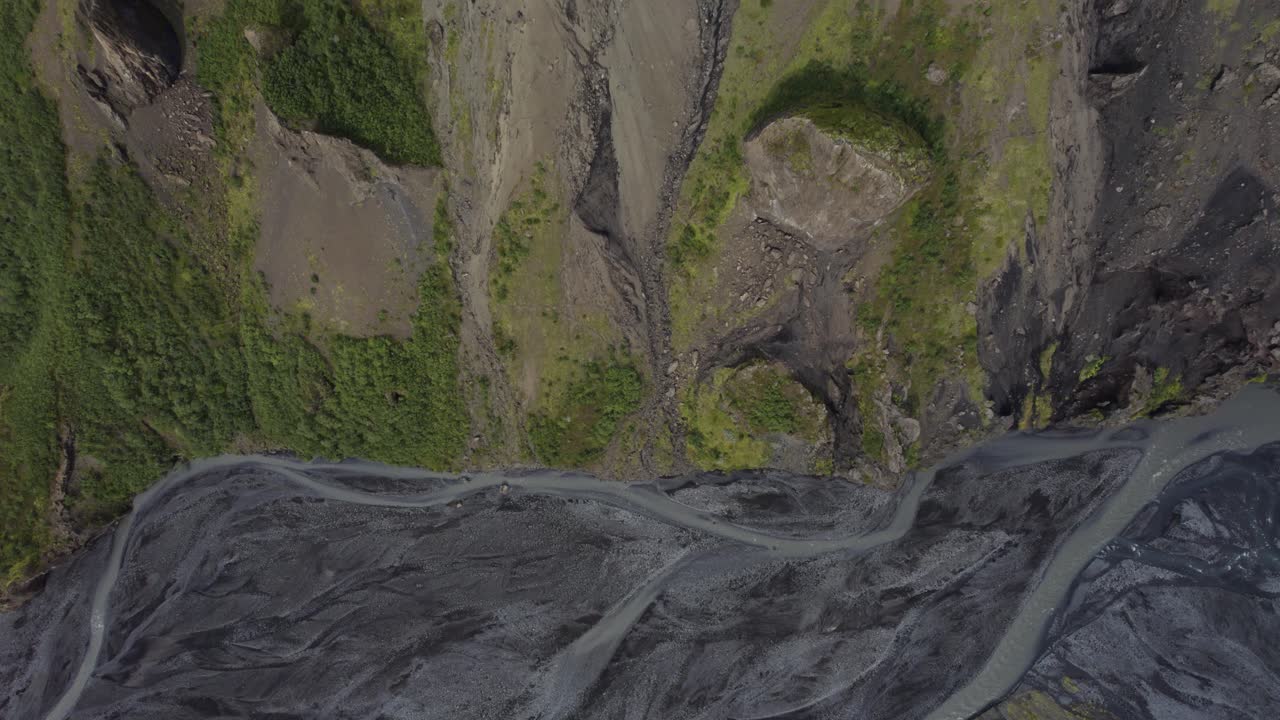 Aerial Birds Eye View Over Majestic Braided River In Thorsmork With Dolly Forward Over Valley Cliffs
