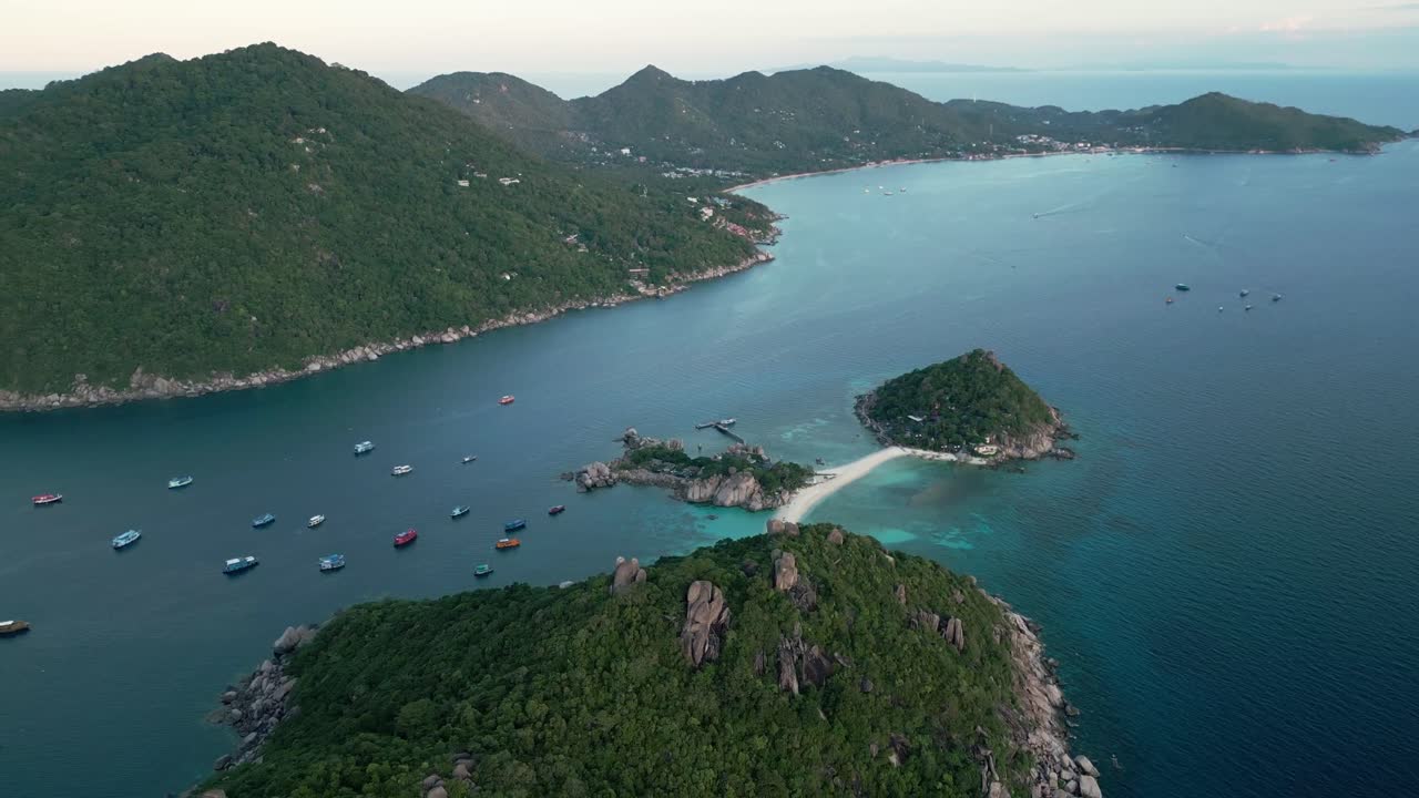 aerial establish of Nang Yuan Island, showcasing its turquoise waters and lush green hills against the open ocean.