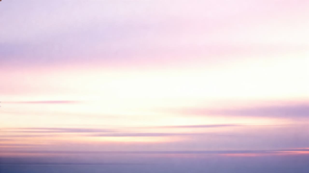Shifting sky layers brightening at sunrise over distant sea, with layered clouds and sun glow