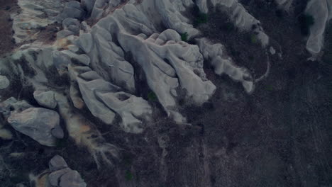 Aerial-view-of-tourists-atop-unique-rock-formations-in-Cappadocia