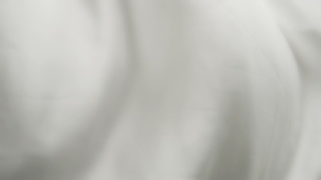 Silky grey fabric waving in the wind. Abstract texture background
