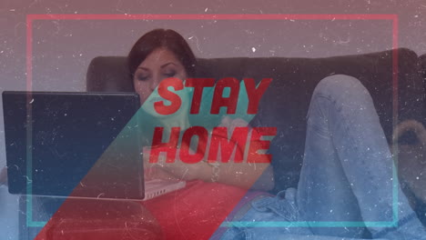 animation of words stay home in frame over caucasian woman using a laptop