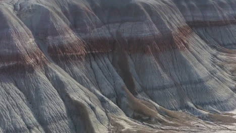 drone shot of the scenic rocks at arizona badlands, with colorful hues of brown, red and more earthy colors,