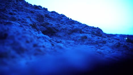 pasos con zapatos deportivos sobre una piedra de roca en la noche