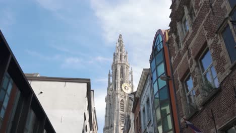 cathedral of our lady seen through a narrow street under blue sky, antwerp
