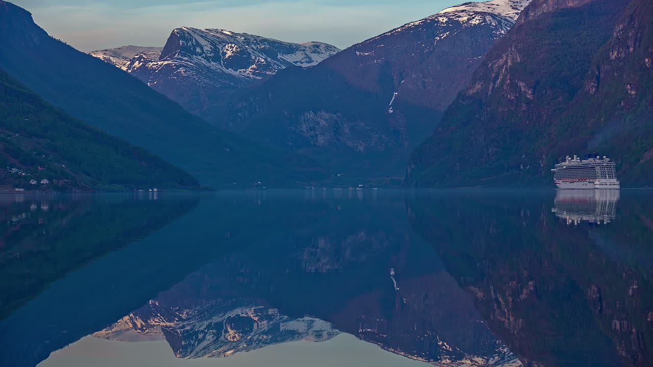 Luxusní výletní loď plující po zrcadlovém odrazu hladiny vody fjordu, časosběr.