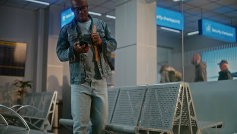 man checking flight information at airport