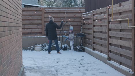 grandfather and granddaughter having fun in the snow