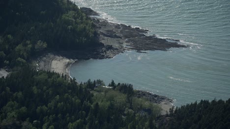 scenic view at pic champlain lake surrounded by green forest at bic national park in quebec, canada